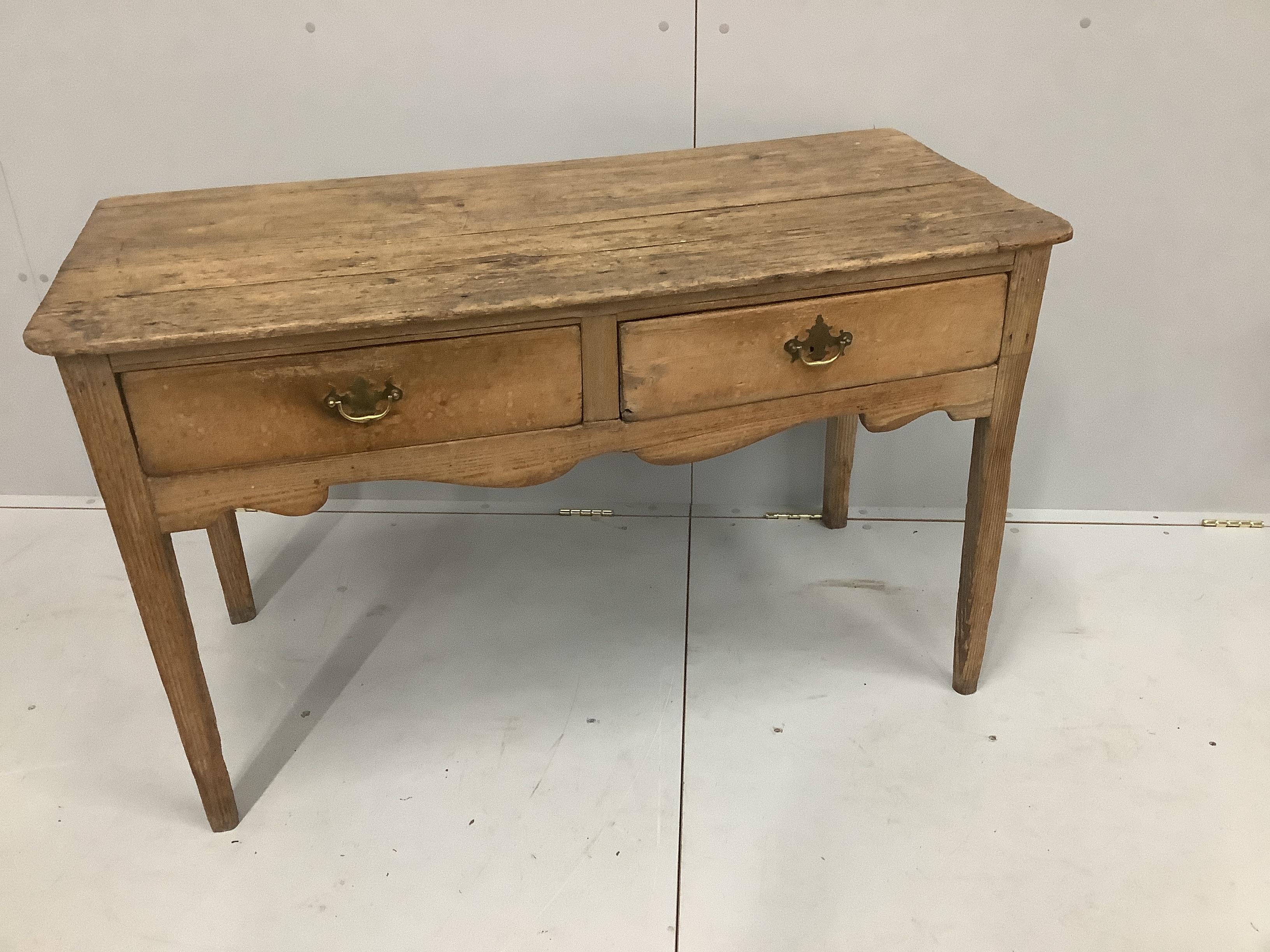 A pine two drawer table, width 121cm, depth 57cm, height 73cm